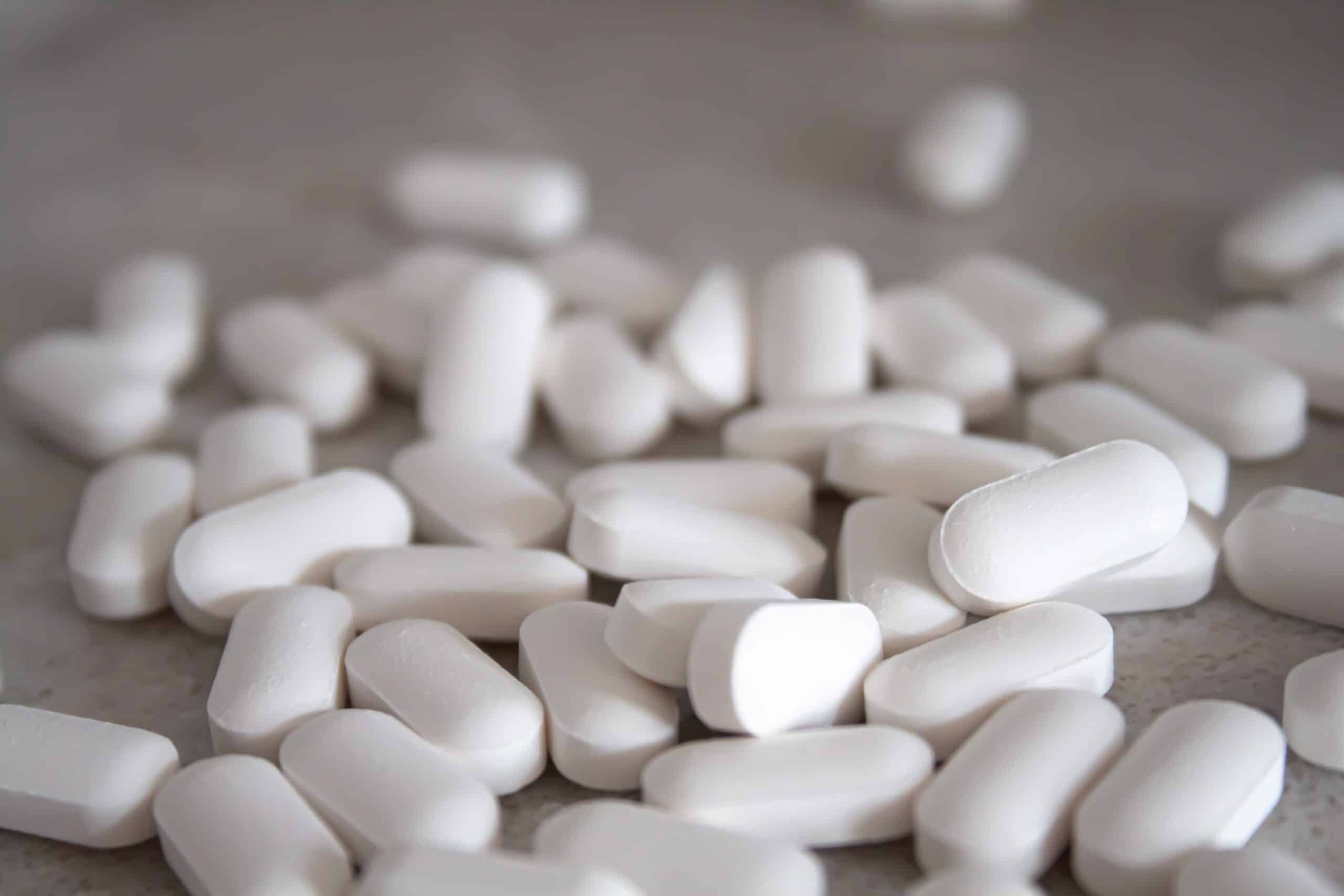 Pile of white tablets on a worktop